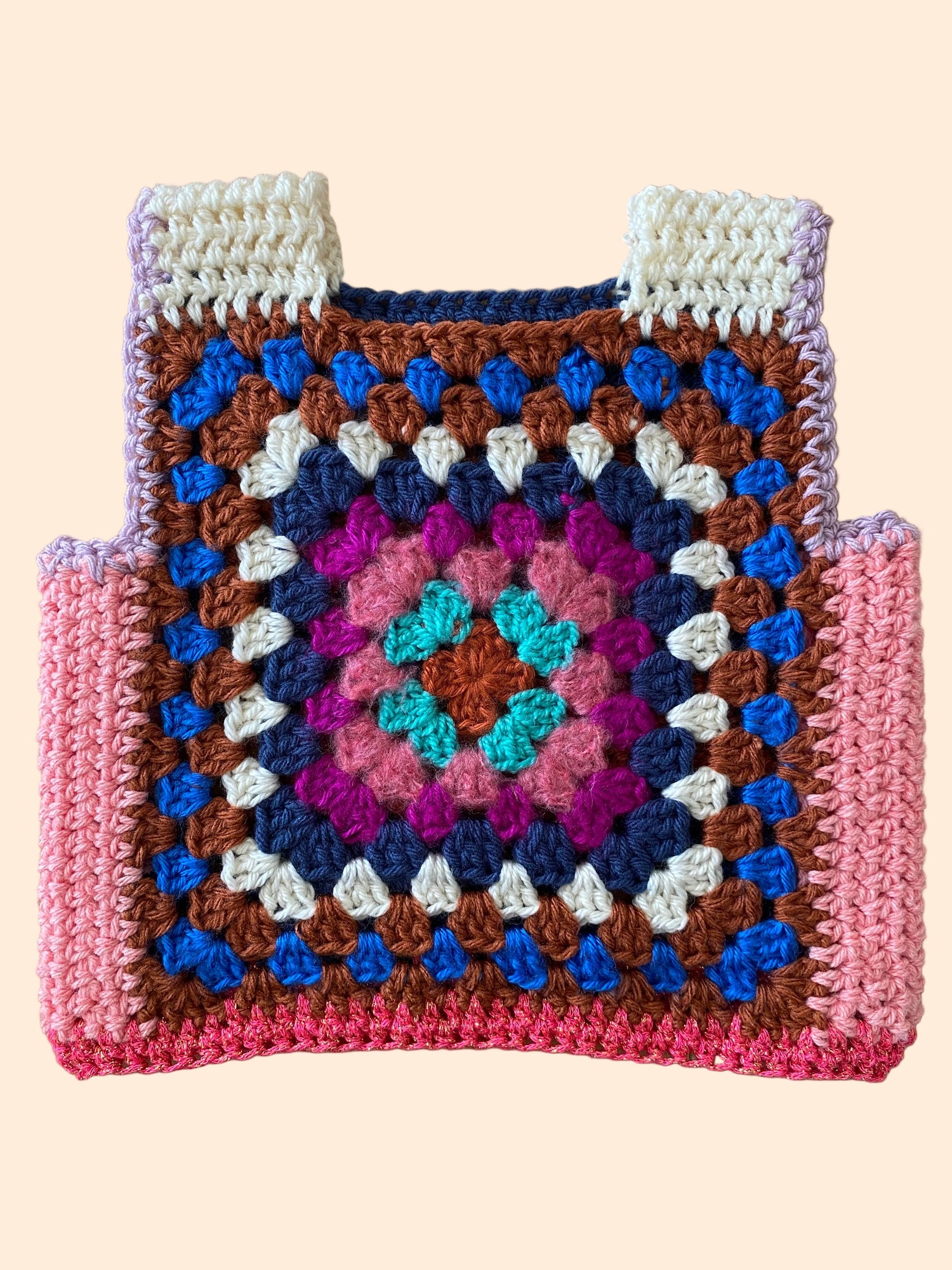 Colorful crocheted vest for children with a geometric pattern