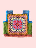 Colorful crocheted child vest with a granny square pattern