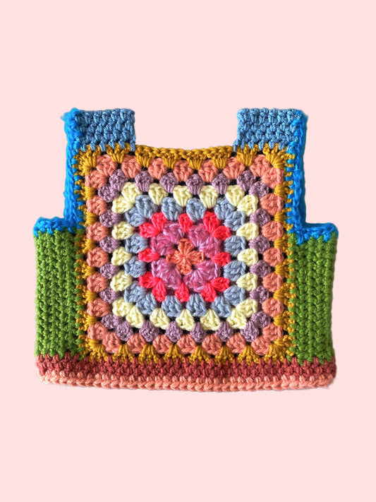Colorful crocheted child vest with a granny square pattern