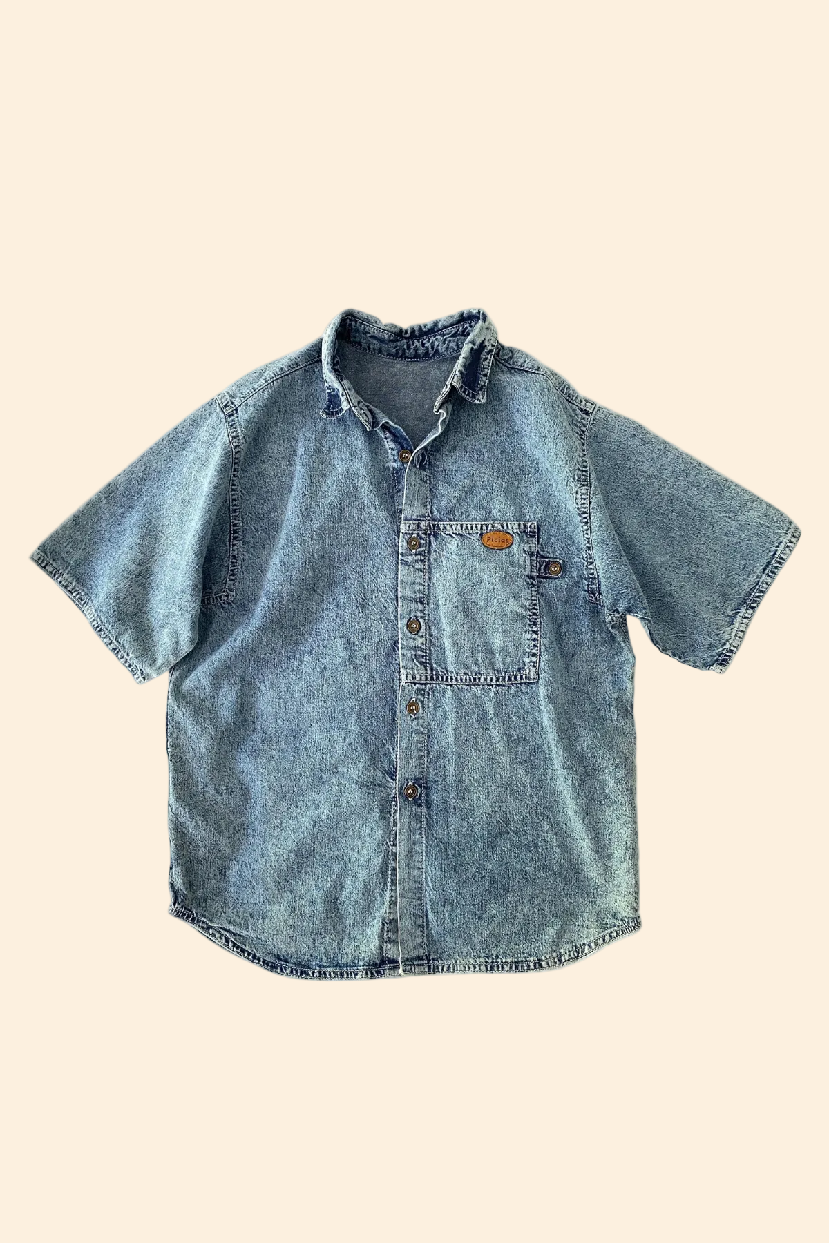 Blue denim shirt on a beige background