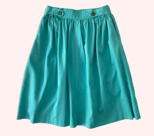 Teal skirt on a textured white background