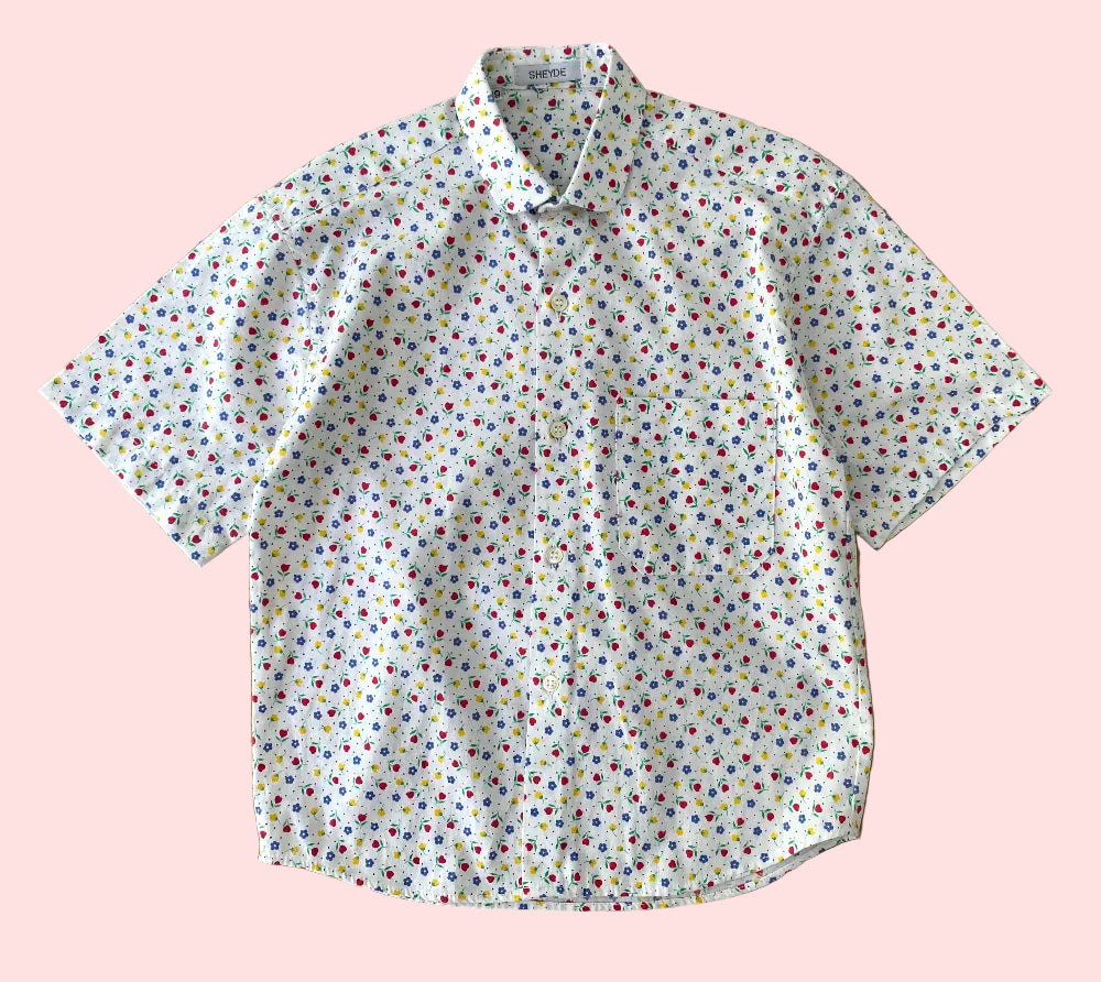 Short-sleeve shirt with a colorful pattern on a wooden surface