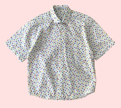 Short-sleeve shirt with a colorful pattern on a wooden surface