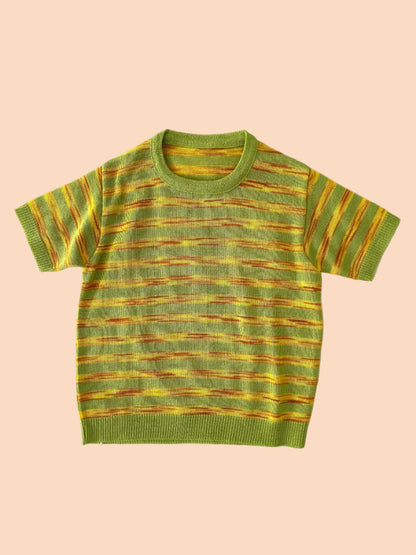 Green and yellow striped top on a textured white background