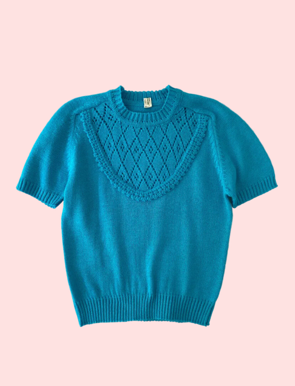 Blue sweater with a textured pattern on a white textured background