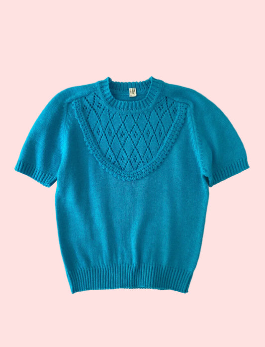 Blue sweater with a textured pattern on a white textured background