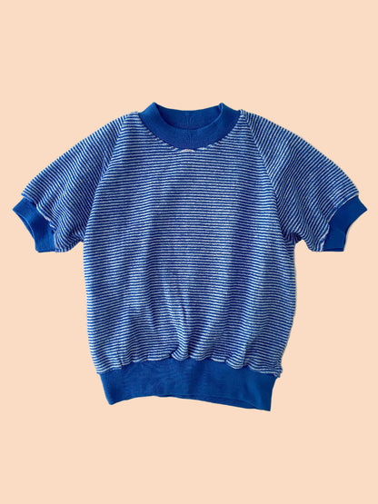 Blue striped sweater on a textured white background