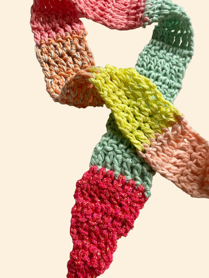 Colorful crocheted scarf on a light background