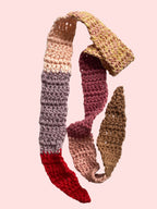 Multicolored crocheted scarf on a white background