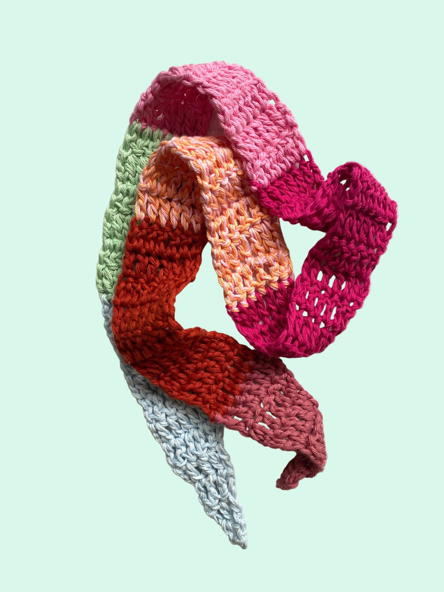 Colorful knitted scarf on a light background