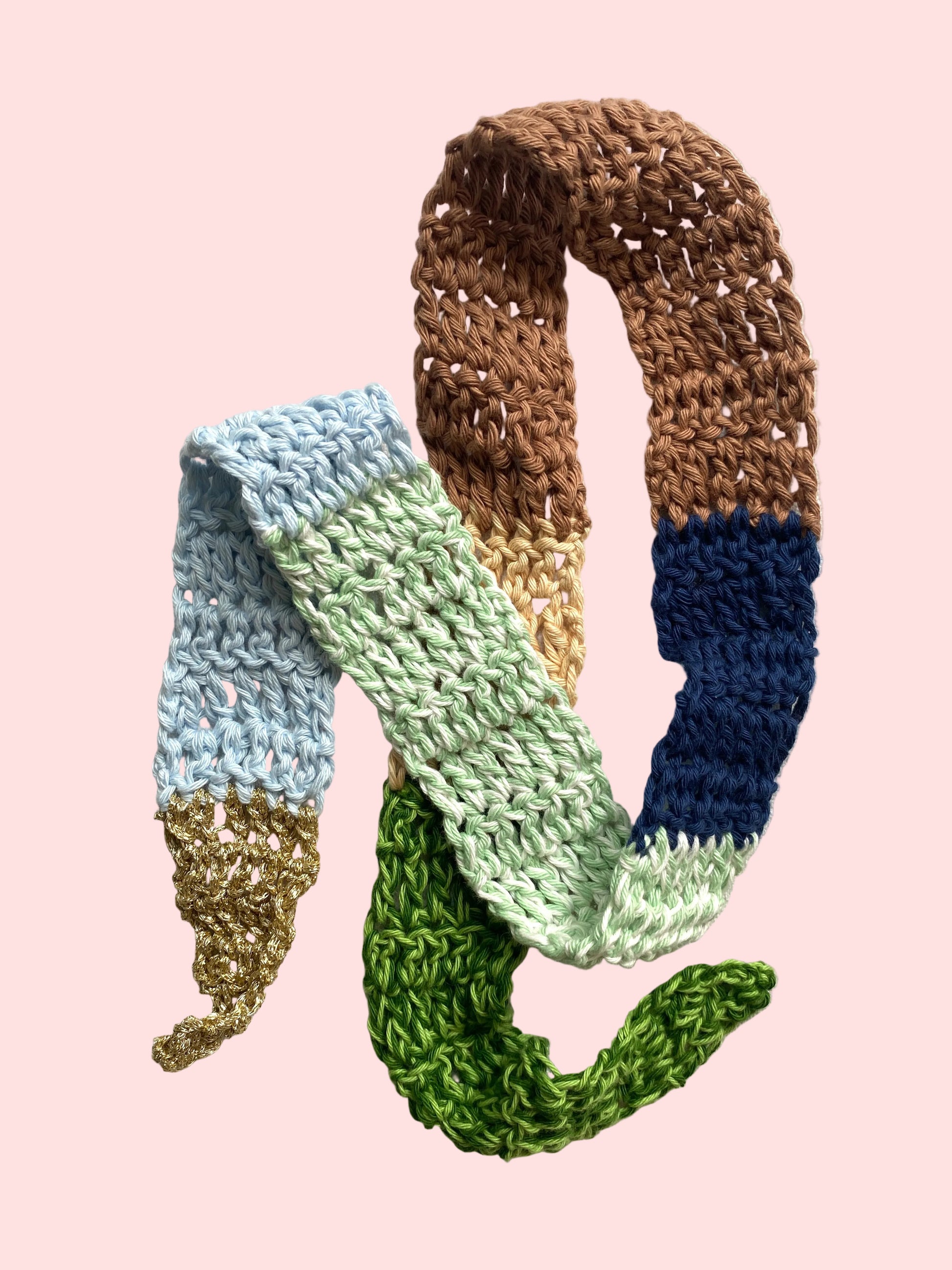 Colorful knitted scarf with gradient pattern on a light background